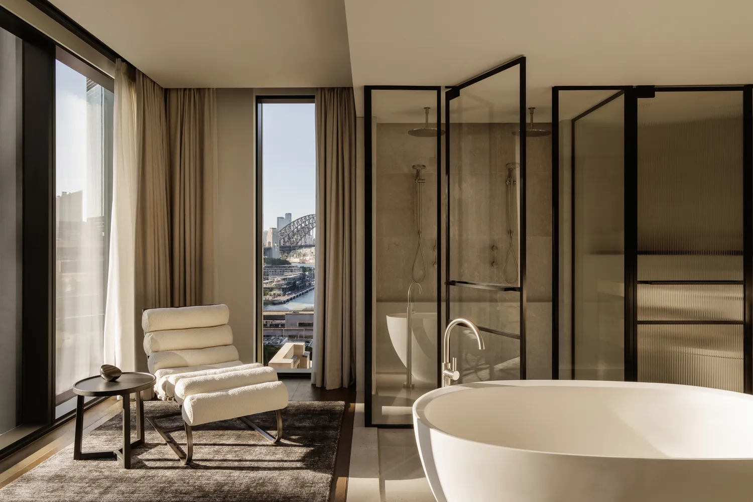 A modern bathroom suite with a freestanding bathtub and a view of Sydney Harbor Bridge in the background.