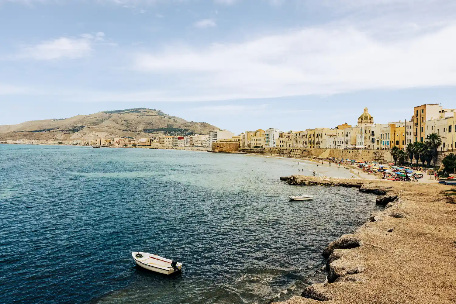 The coastal town of Syracuse in Sicily with historic buildings along the water.