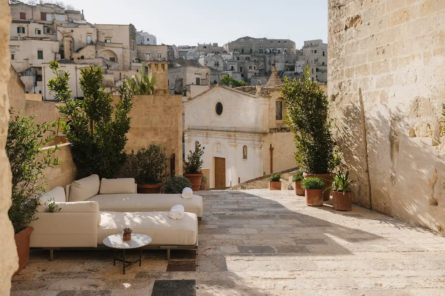 A rustic outdoor courtyard with stone walls and traditional Mediterranean architectural details.