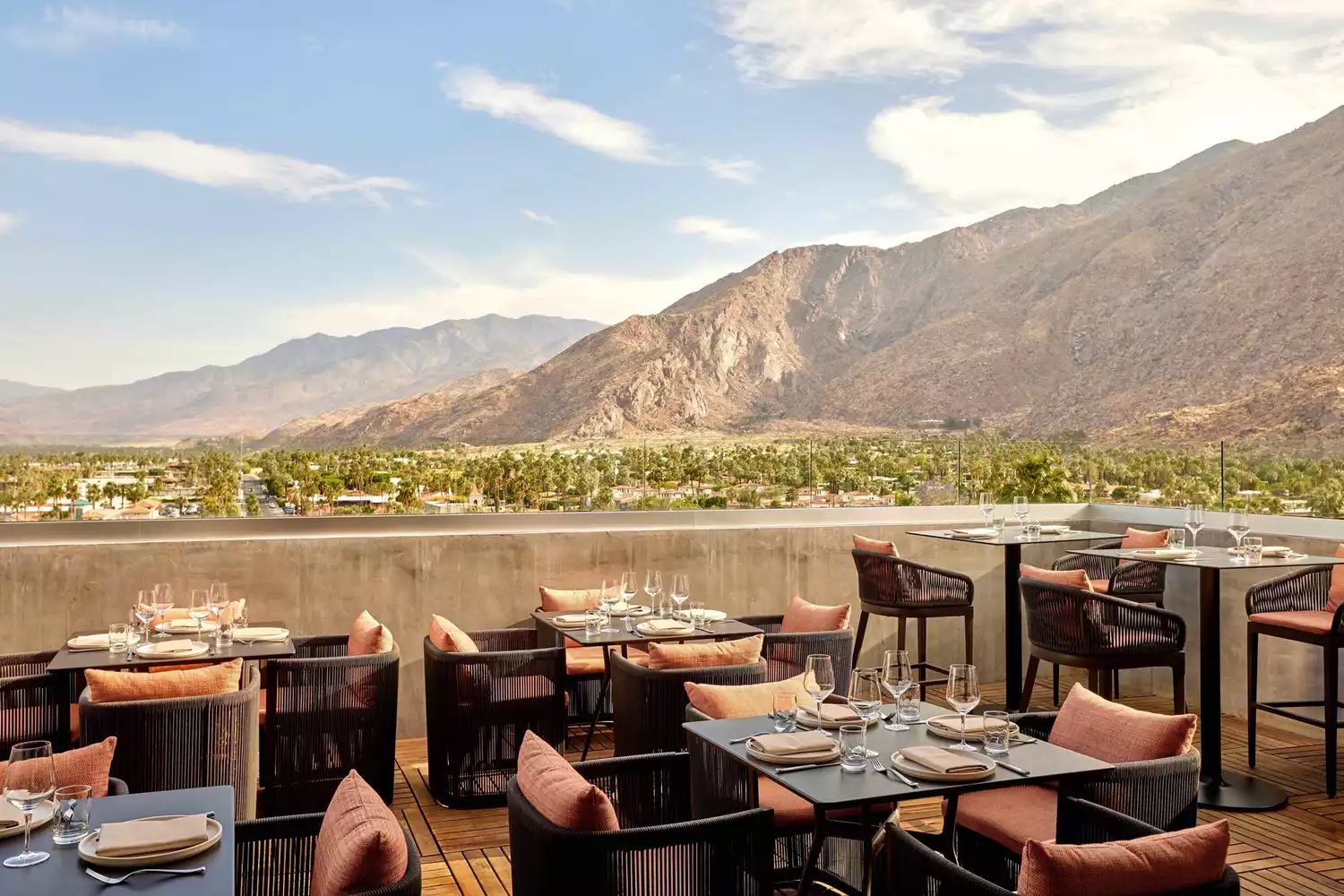 A restaurant terrace set for dining with clear views of the San Jacinto Mountains.