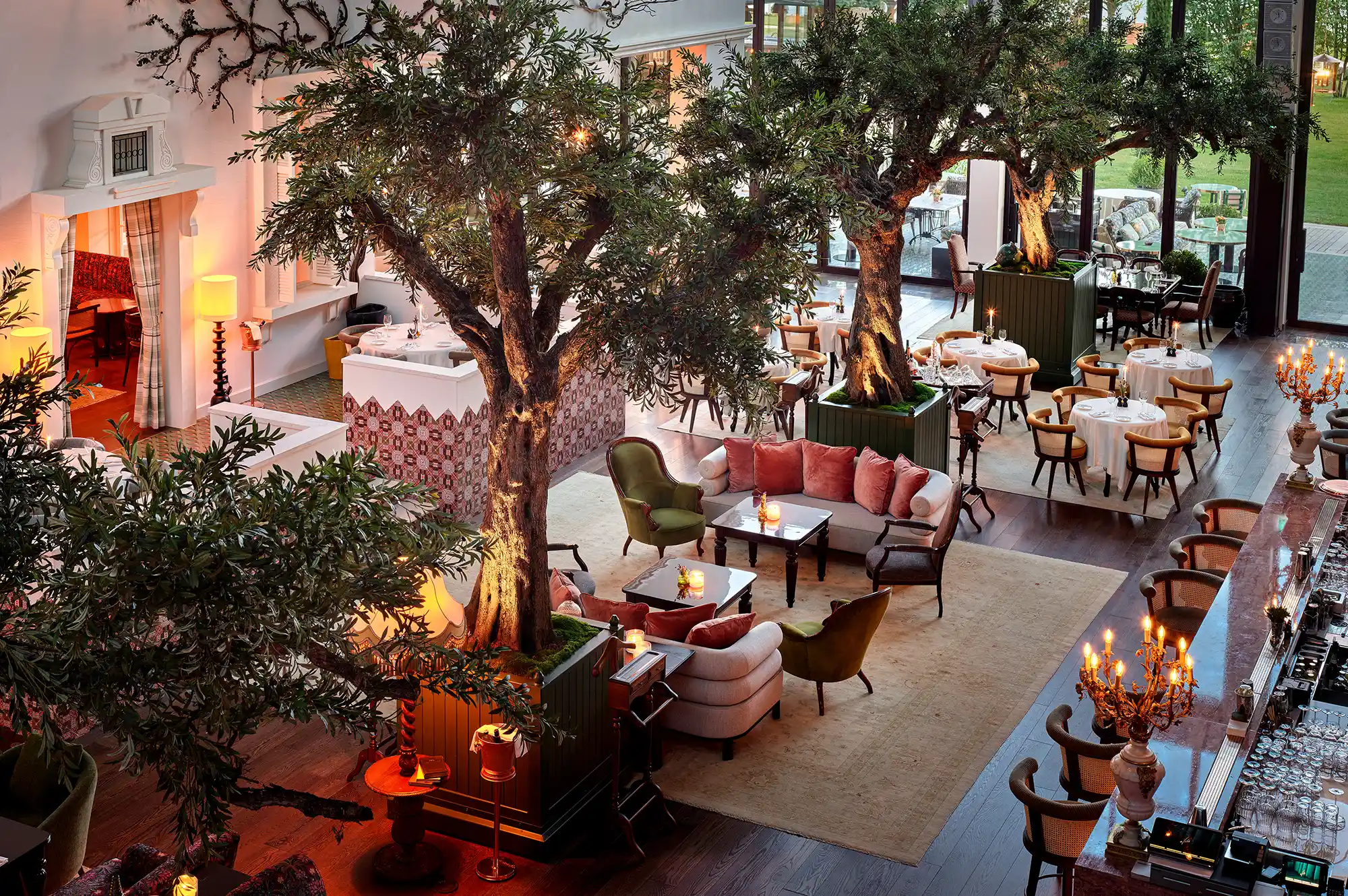 Interior of a high-end restaurant with indoor trees and elegant table settings at Aliée Istanbul.