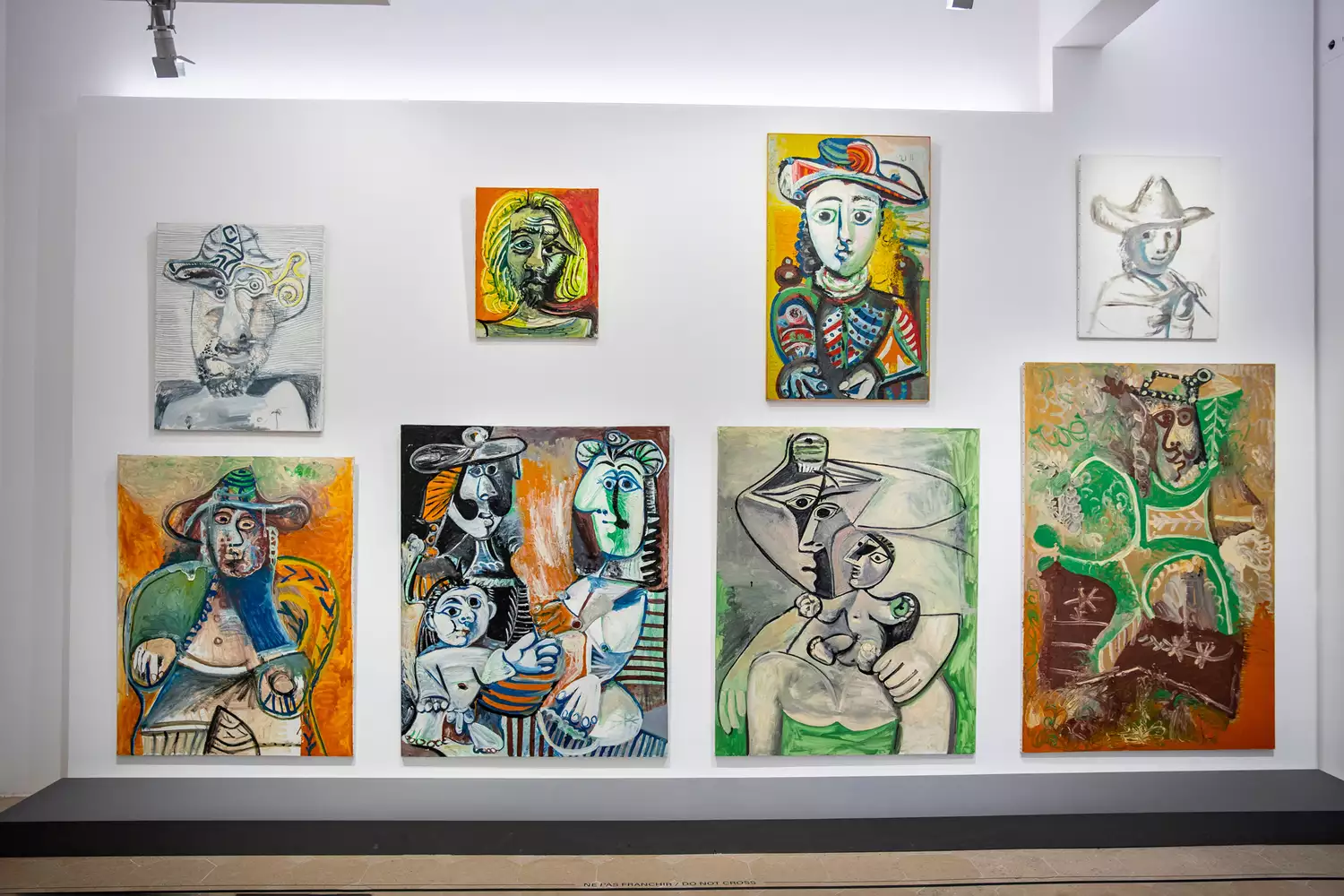 Detailed view of several Picasso paintings displayed on a gallery wall in the Picasso Museum.
