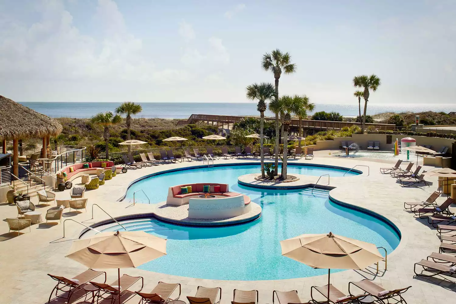 Expansive outdoor pool at The Ritz-Carlton Amelia Island at dusk.