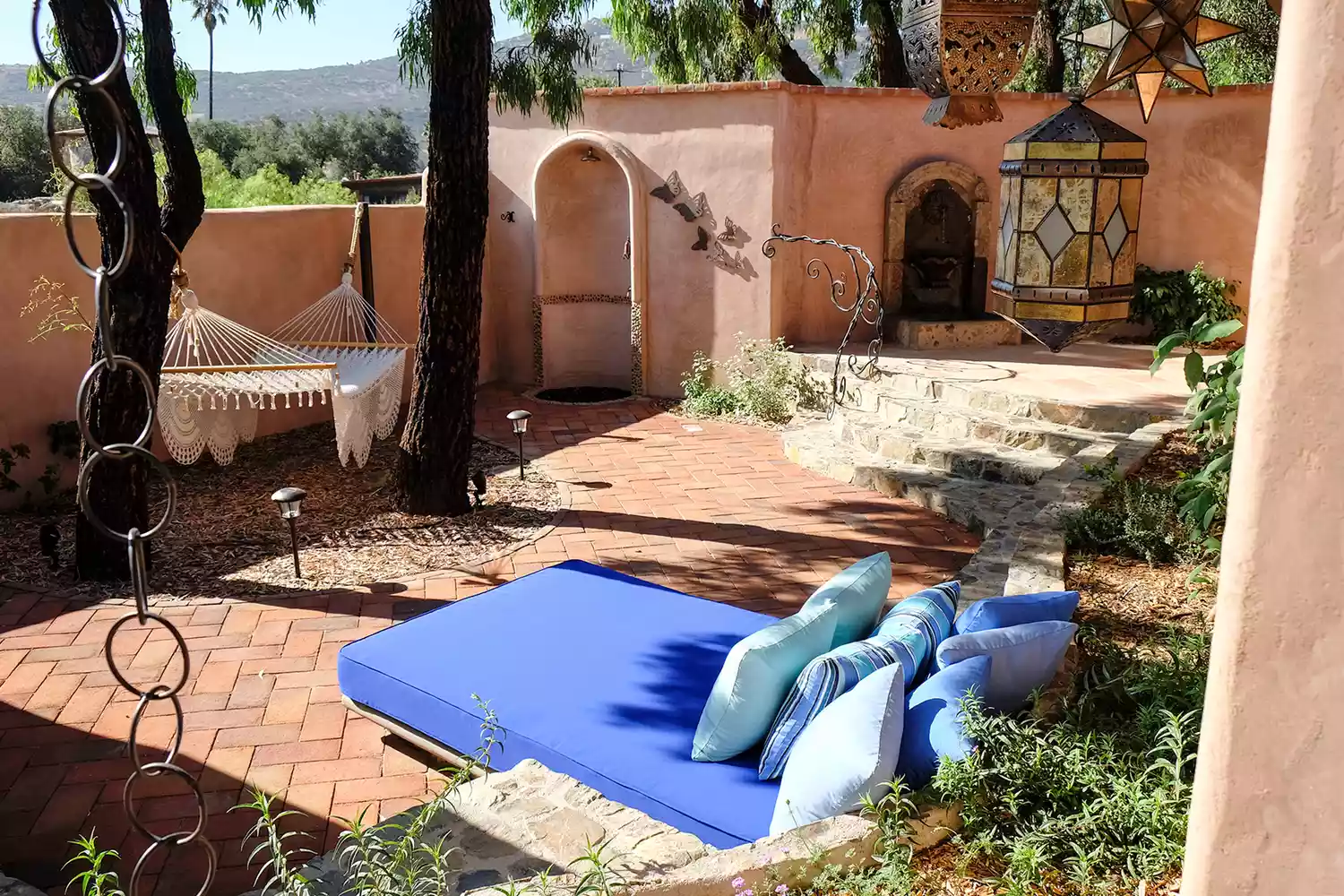 Exterior view of the Cielo Villa at Rancho La Puerta in Mexico showing a stone terrace with a view of the mountains.