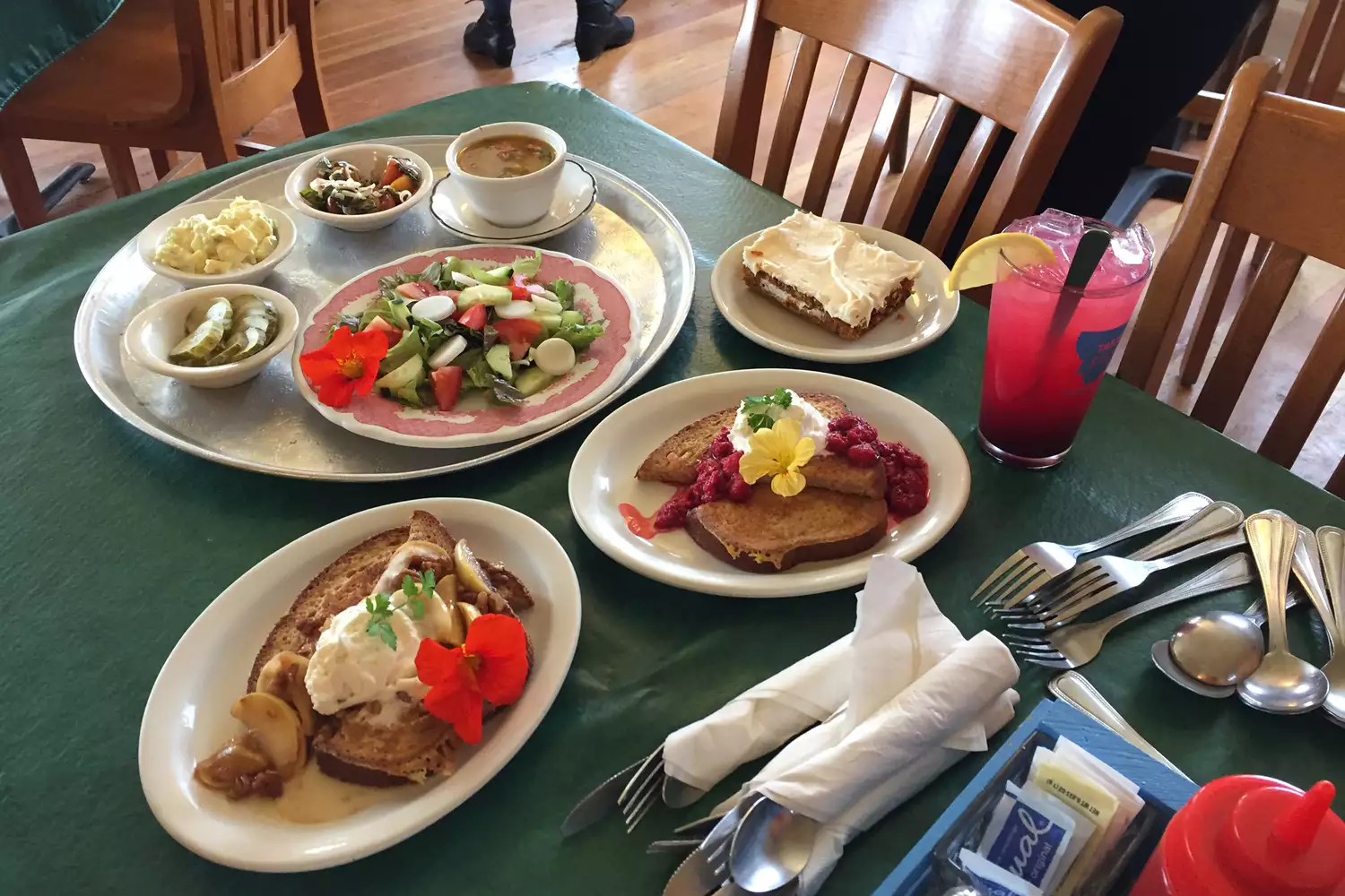 Various breakfast dishes and coffee on a table at a local cafe.
