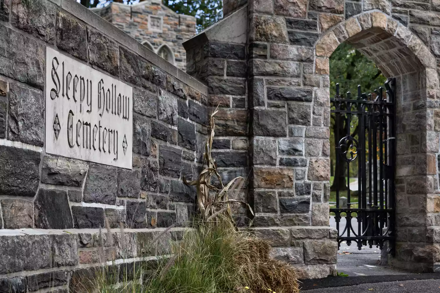 The ornate wrought iron gate leading into the historic Sleepy Hollow Cemetery.