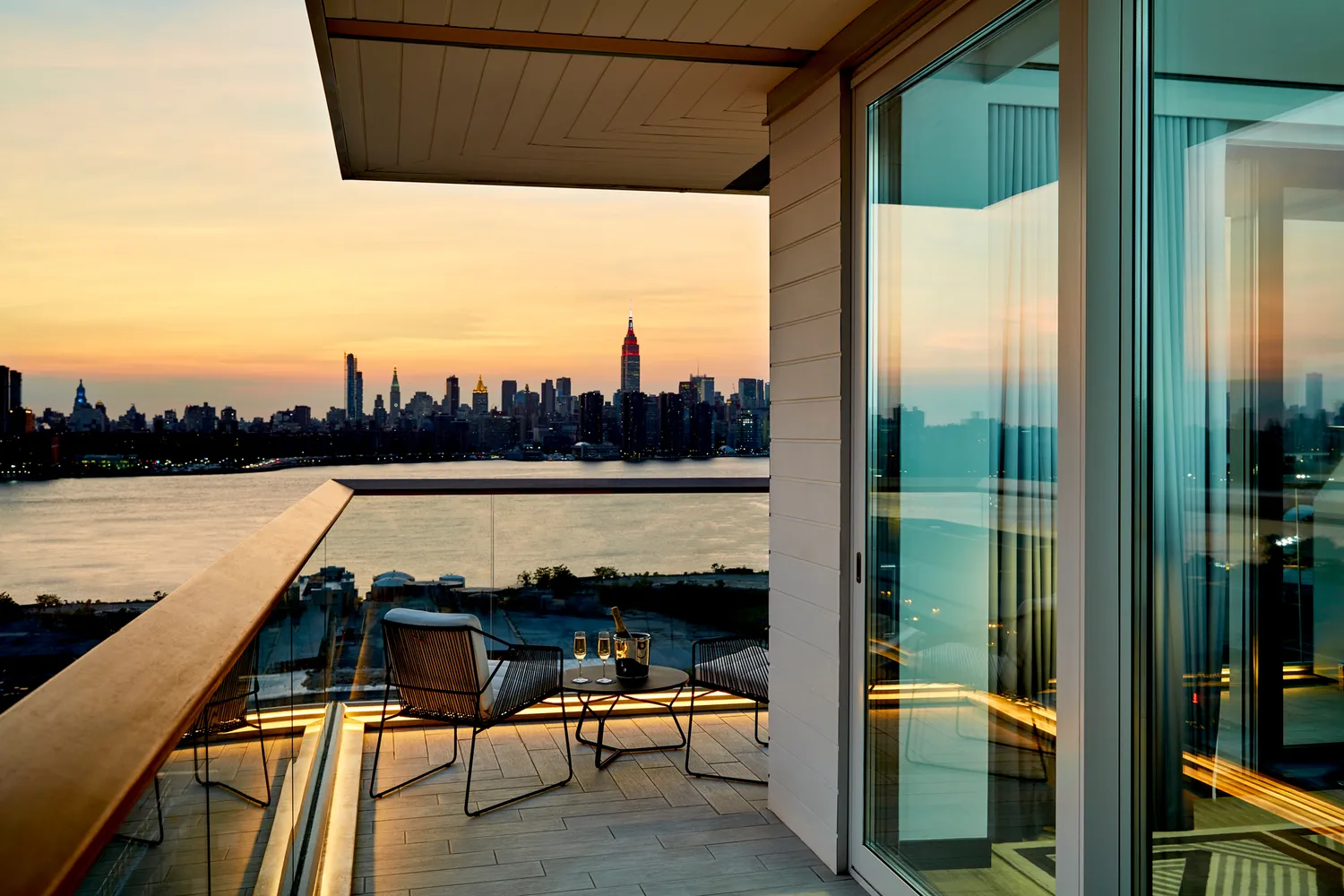 Manhattan skyline views from a private balcony overlooking the East River in Williamsburg.