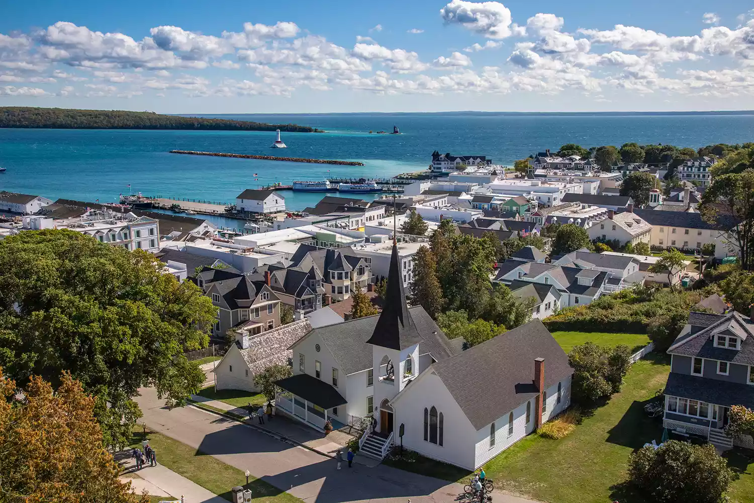 Wide shot of the historic downtown area of Mackinac Island with bicycles and pedestrians.