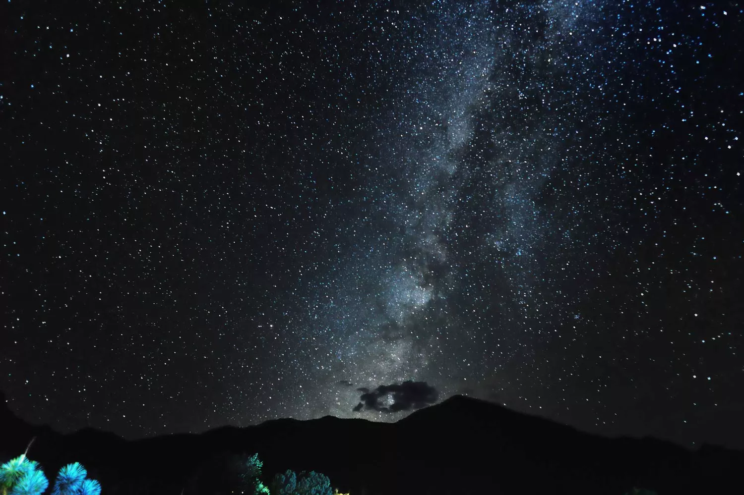 The bright band of the Milky Way galaxy visible above the desert landscape of Big Bend National Park.