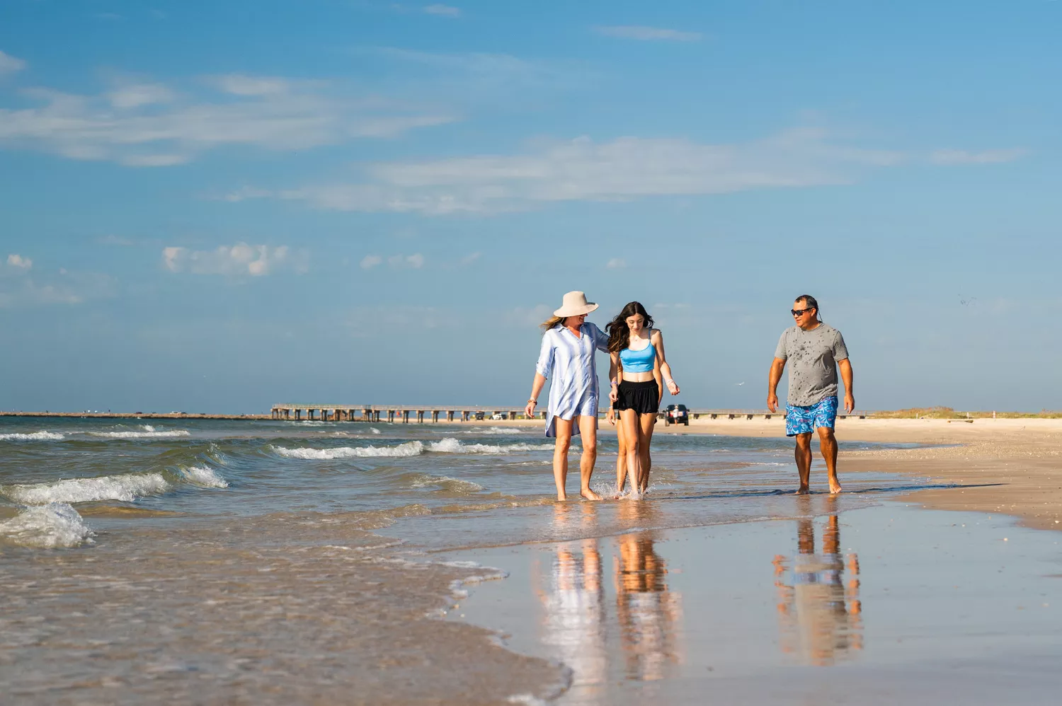 A family searching for shells on the sandy shores of Matagorda Island