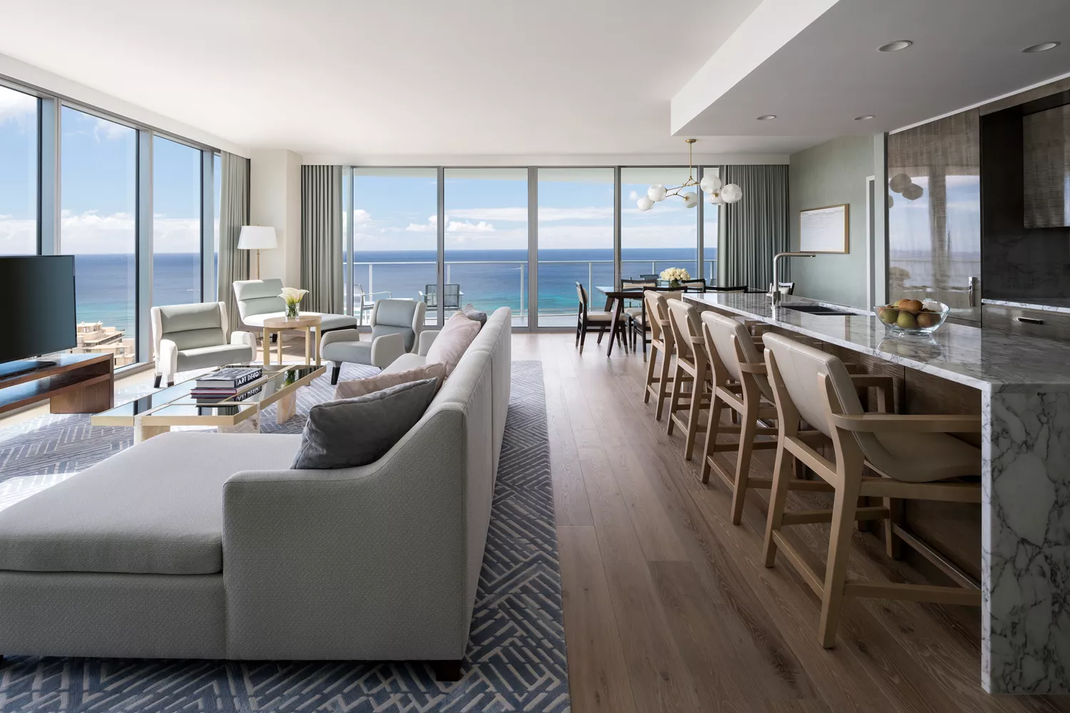 The modern and spacious living room of a Ritz-Carlton penthouse with contemporary decor.