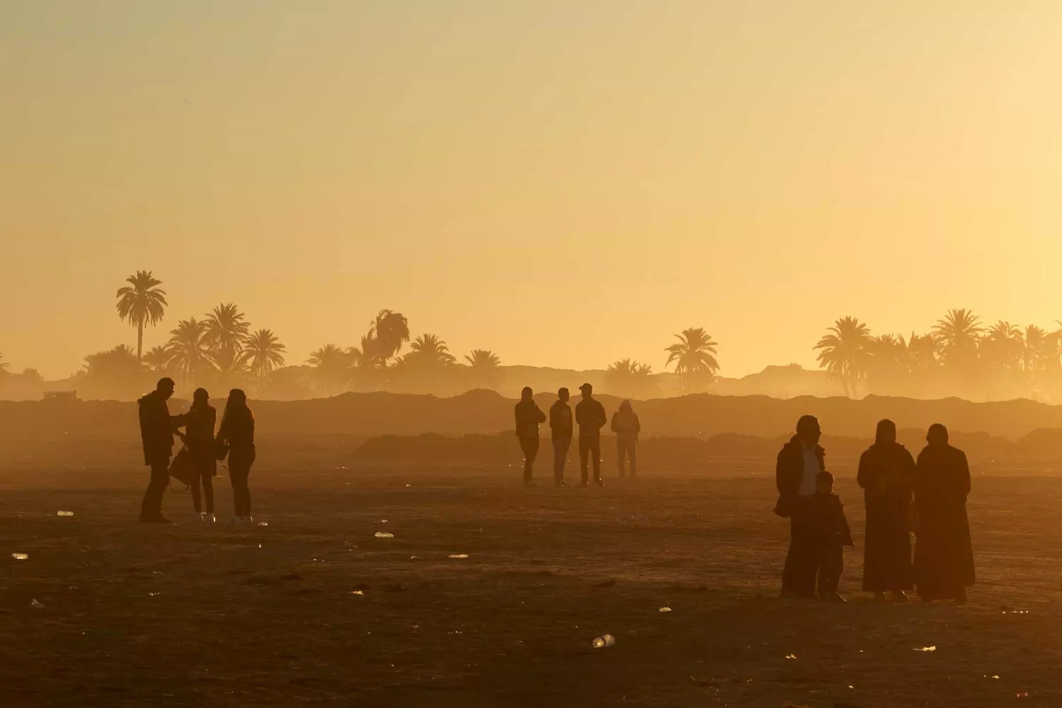 Festival participants and camels in the desert during the International Sahara Festival in Douz.