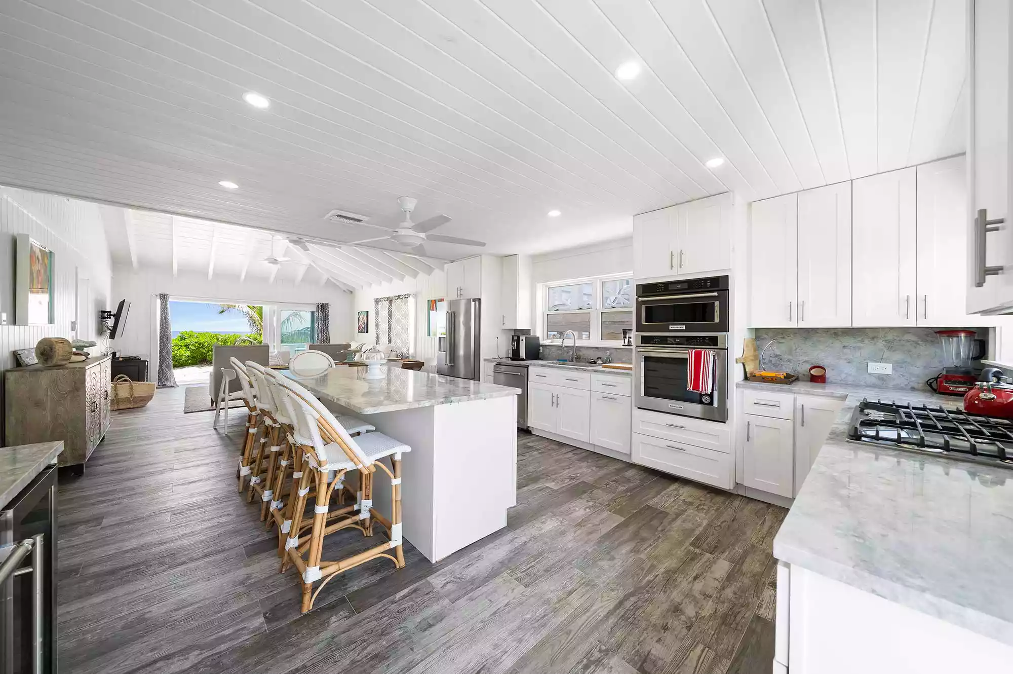 A modern, fully-equipped kitchen inside a luxury island cottage with wooden finishes.