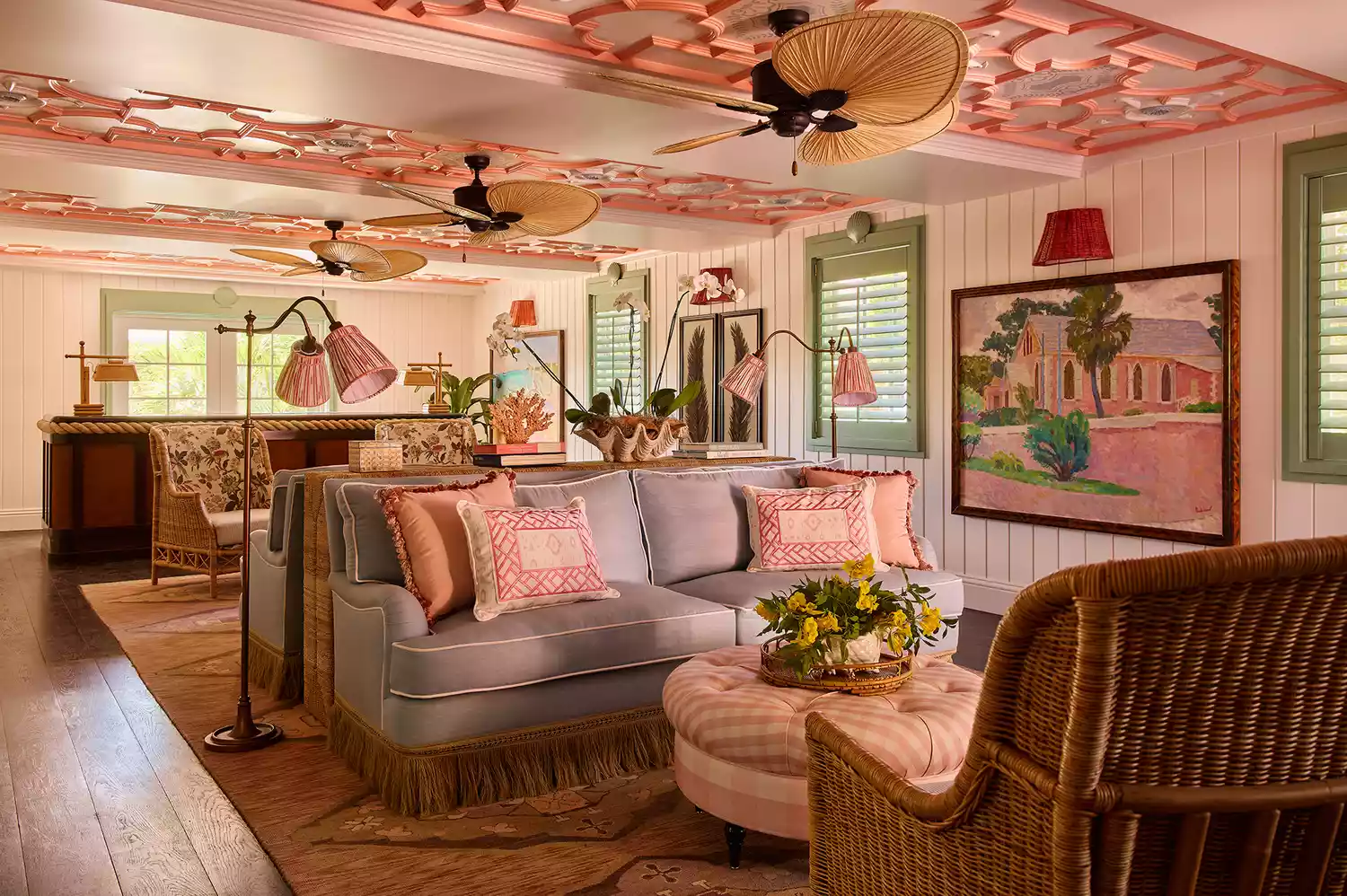 The coral pink lobby of Coral Sands featuring tropical artwork and elegant seating.