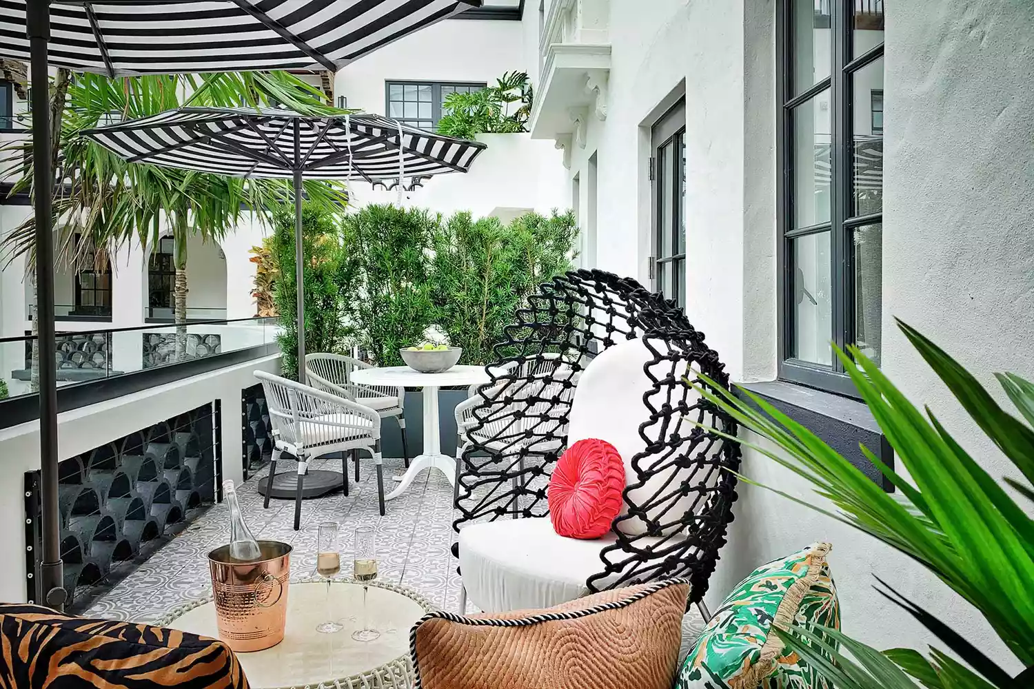 Architectural patio at White Elephant Palm Beach with chic white furniture.