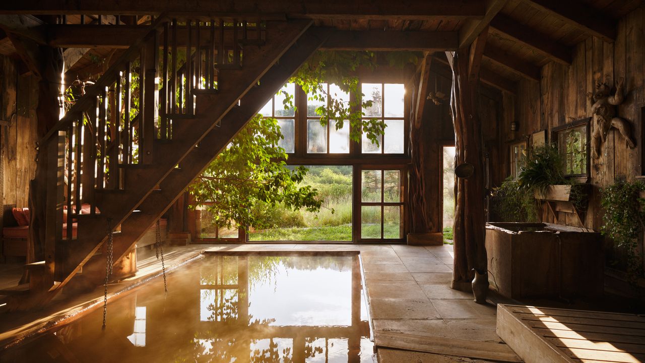 Wide shot of a minimalist luxury thermal pool at a spa resort.