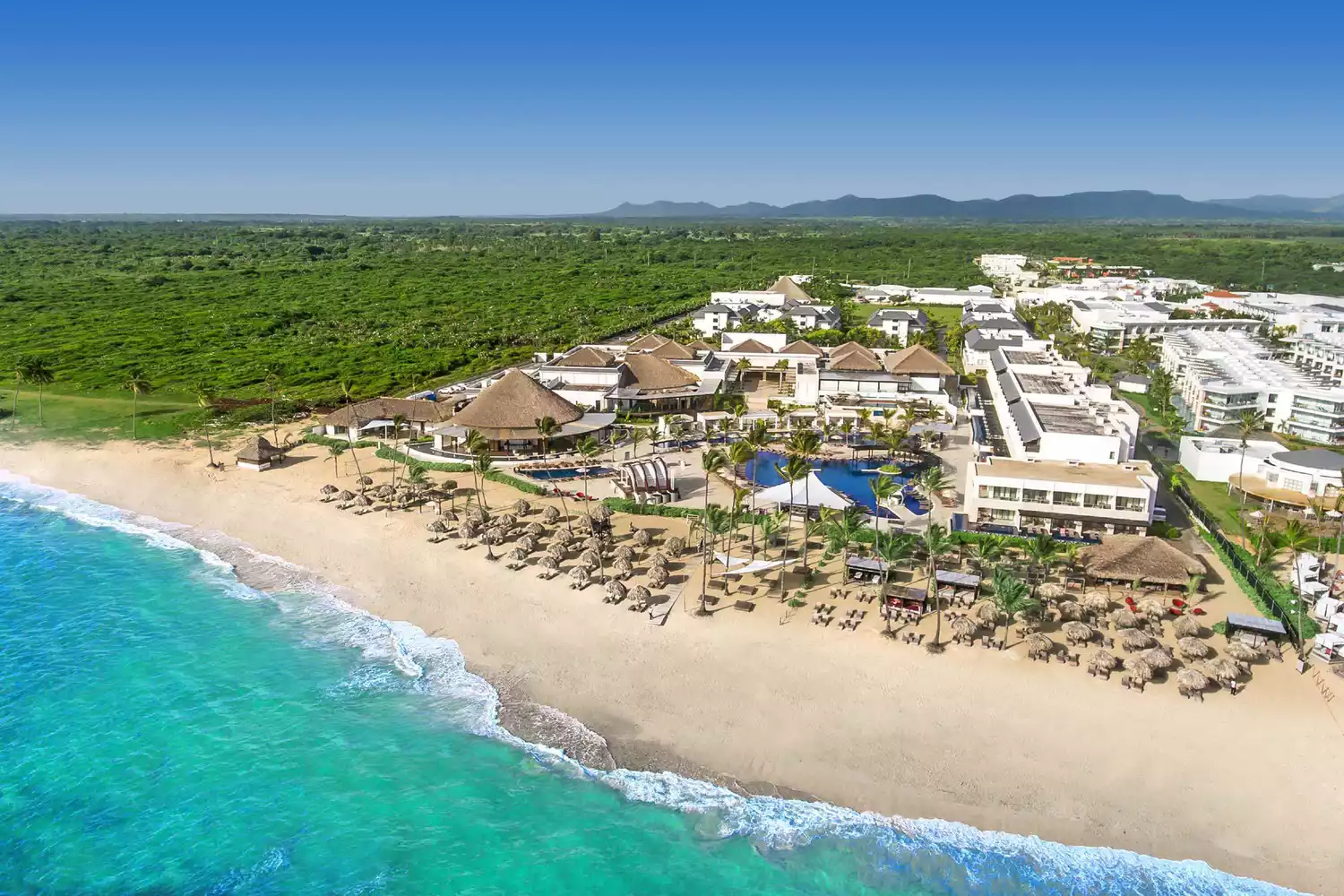 Aerial perspective of the white sand beach and turquoise water at Royalton CHIC Punta Cana.