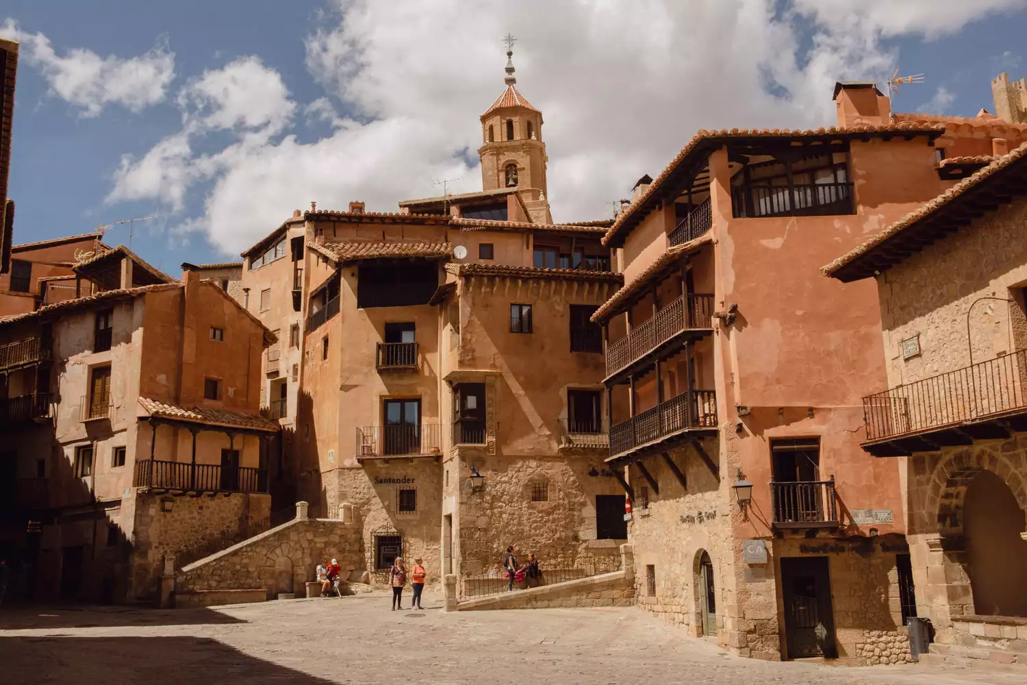 A public square with historic buildings in Albarracin, Spain.