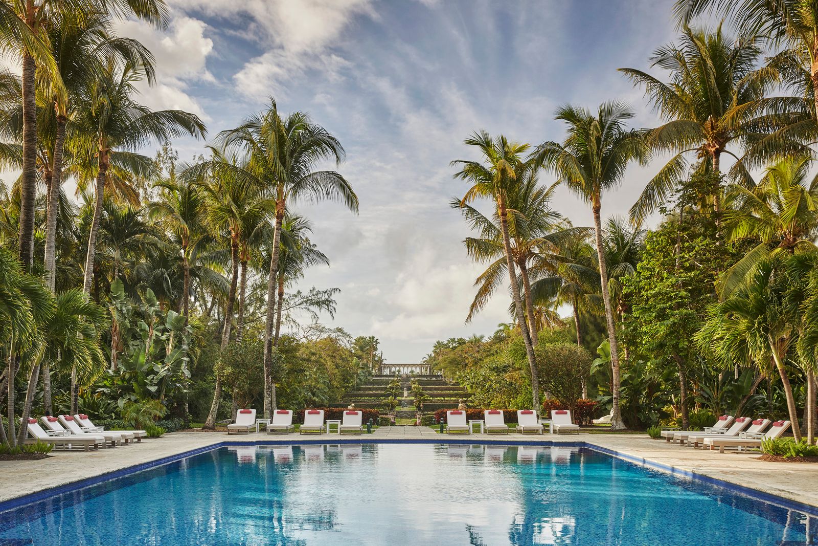 A luxury Caribbean resort building surrounded by palm trees and tropical landscaping.