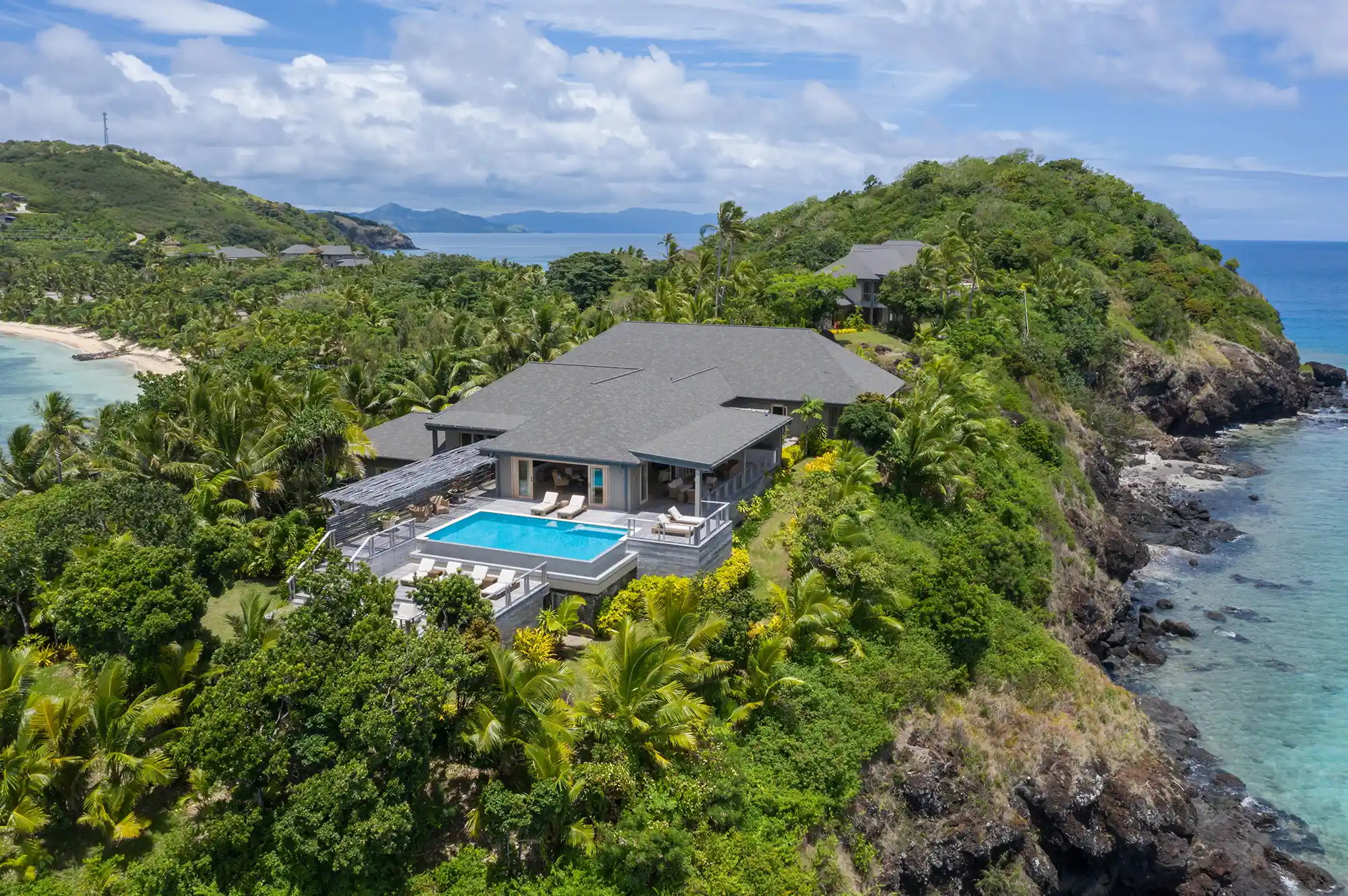 A hilltop luxury residence at Kokomo Private Island featuring a private infinity pool and panoramic ocean views.