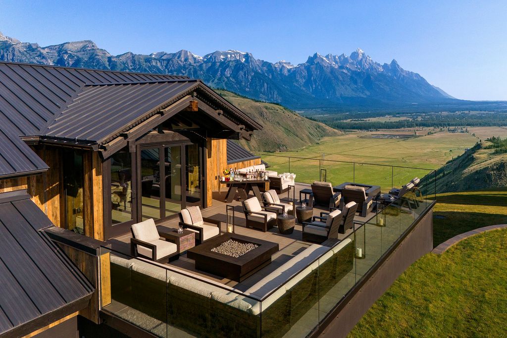 A luxury suite interior at Hotel Yellowstone with a view of the mountains through large windows.