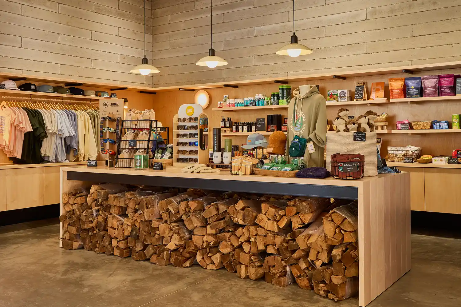 The interior of the AutoCamp general store featuring wooden shelves stocked with local artisanal goods.
