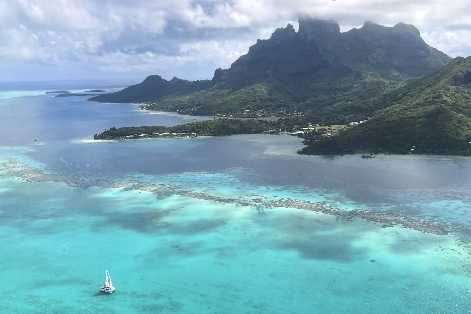 Aerial view of Bora Bora's turquoise lagoon and emerald volcanic peaks.