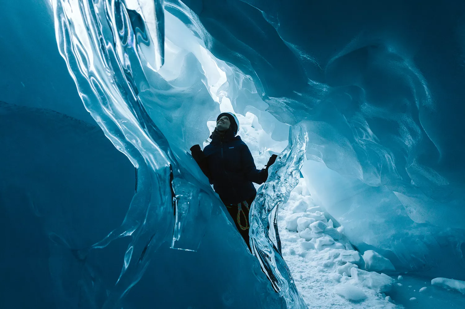 The deep blue glow of an ancient ice cave formation in the Ruth Glacier area.