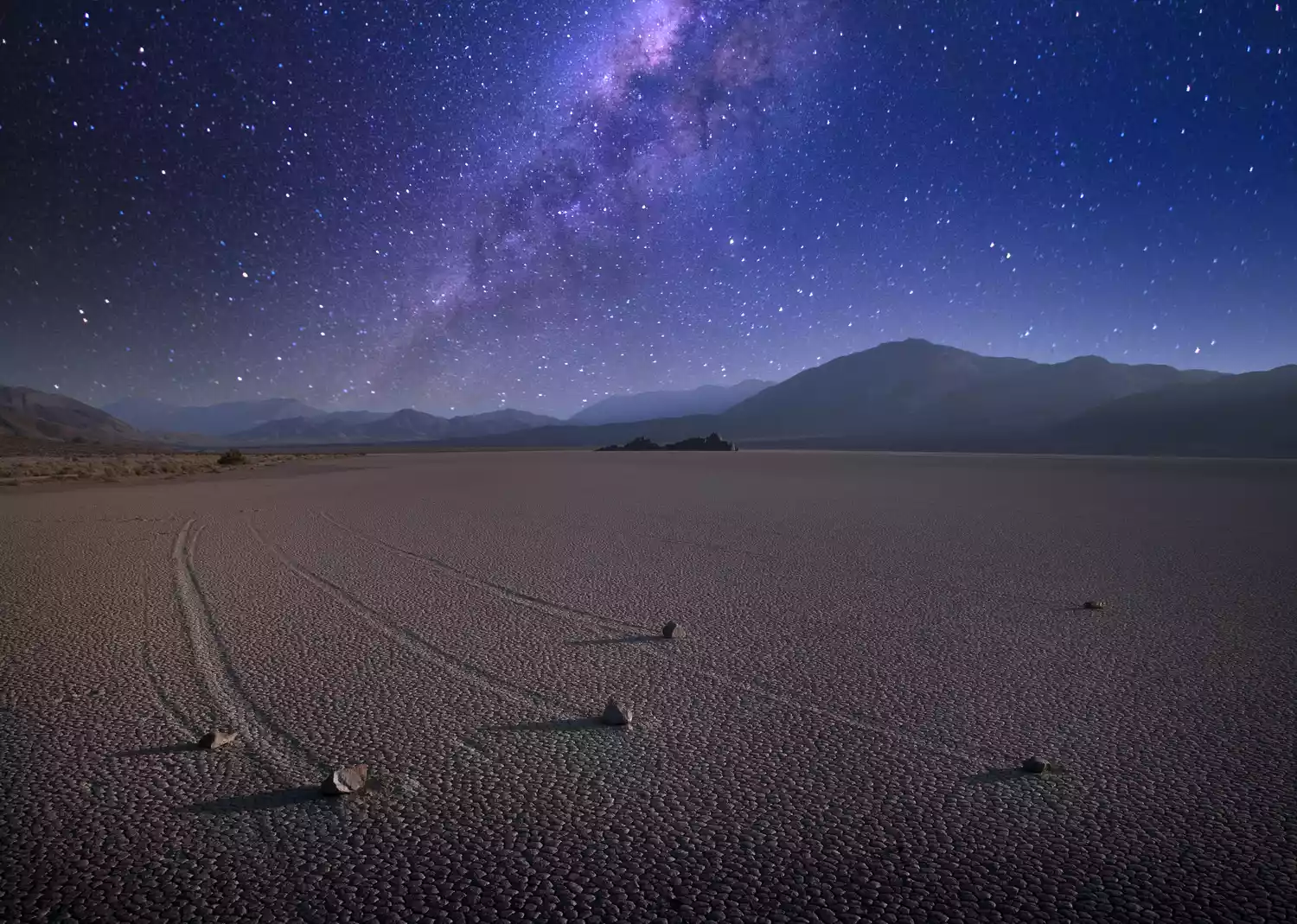 The Racetrack Playa in Death Valley National Park under a canopy of stars and the Milky Way.