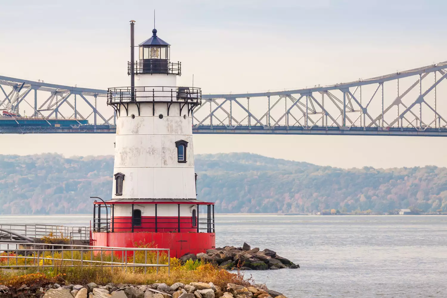 The Sleepy Hollow Lighthouse on the Hudson River with the Mario M. Cuomo Bridge in the background.