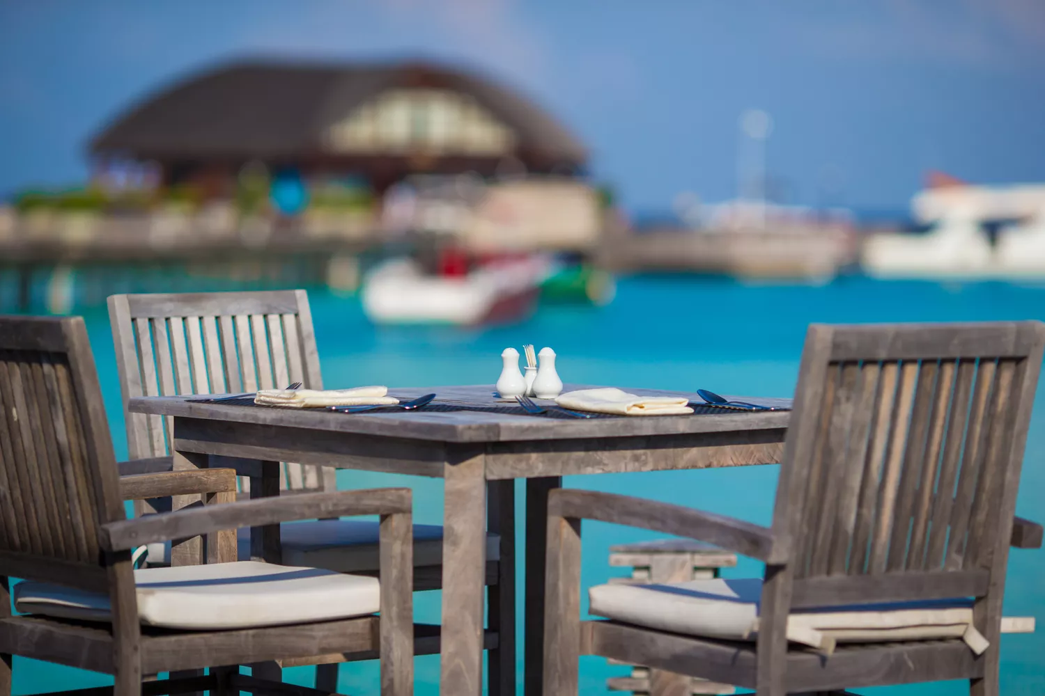 An empty open-air luxury cafe overlooking the sea on an exotic island.