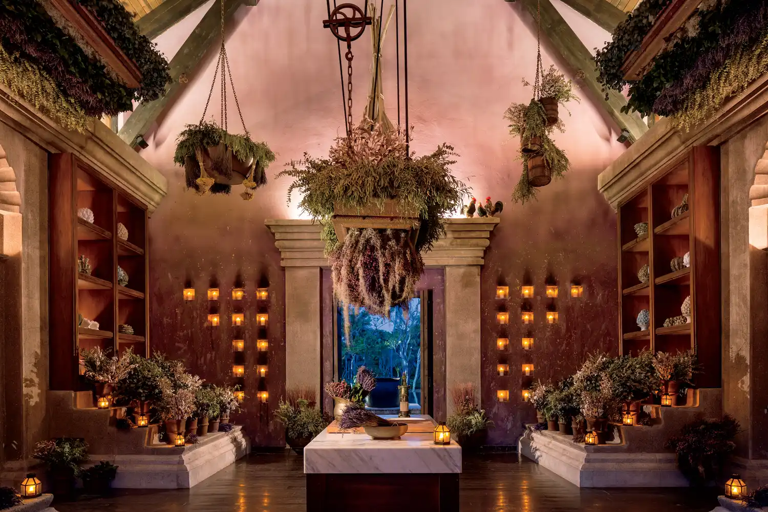 Interior of the Spa Botánico apothecary featuring elegant candles and hanging greenery.