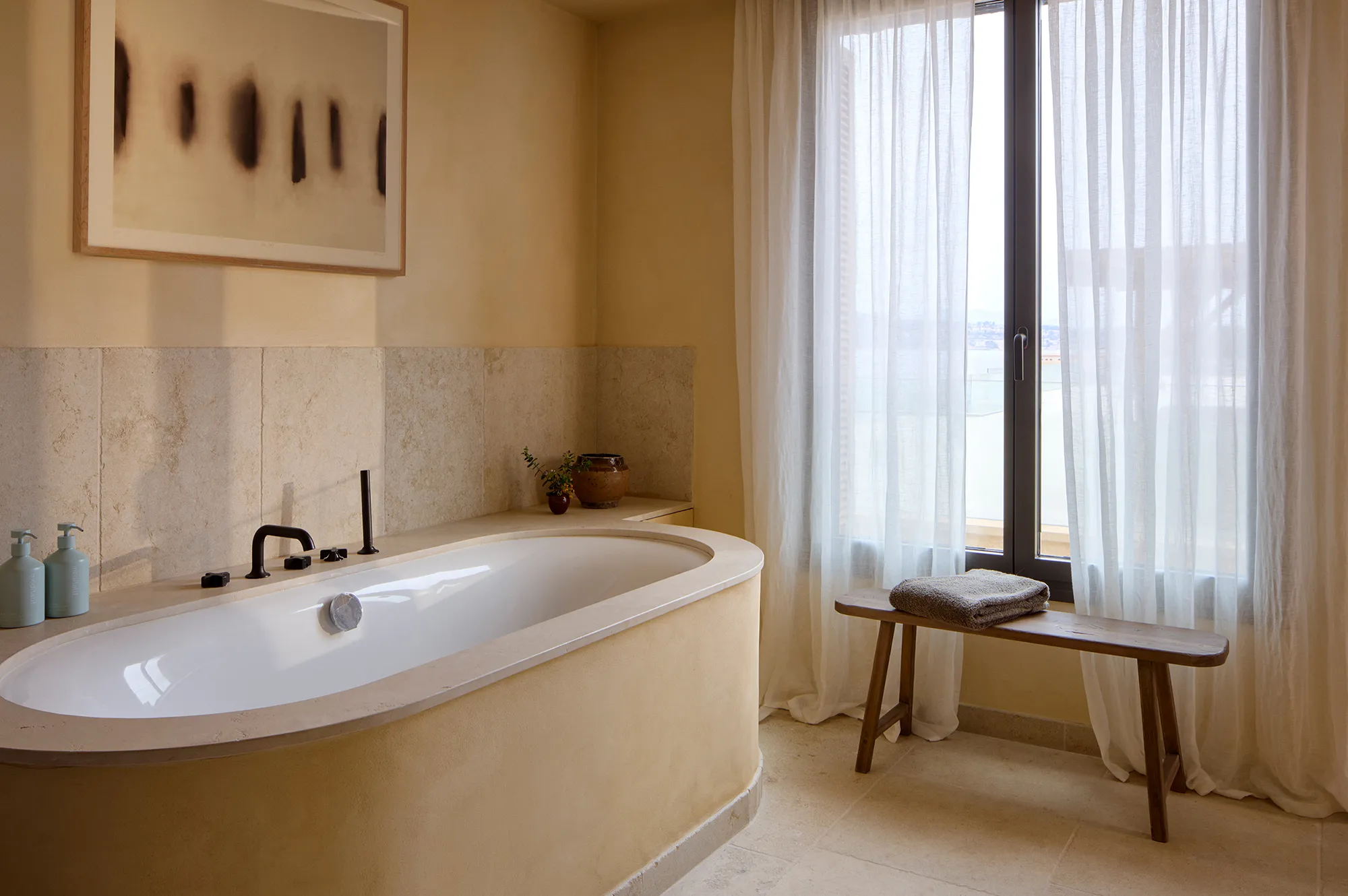 Modern bathroom interior featuring a window with sea views and minimalist decor.