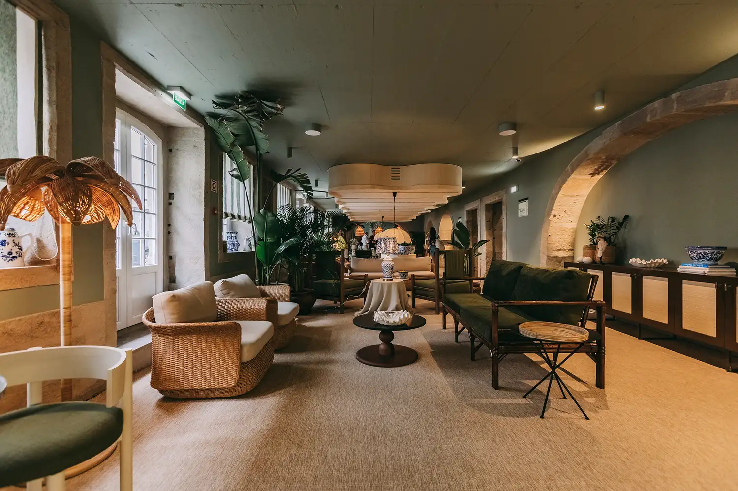 Luxurious reception and lobby of Torel Terra Brava with lush indoor plants and natural sunlight.