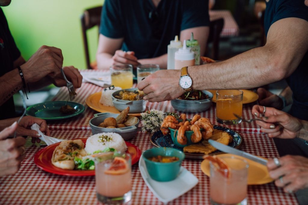 A group of people enjoying local Puerto Rican cuisine and brunch at a table in Old San Juan.