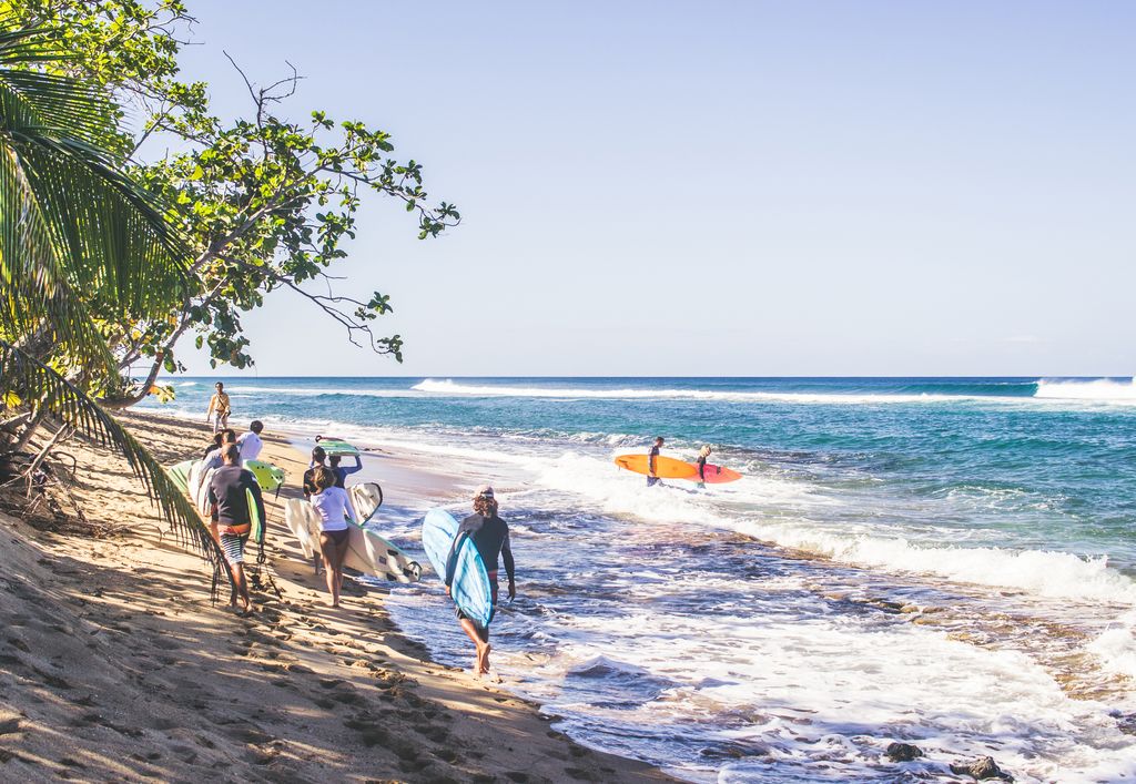 Instructors and students from a surf school preparing to enter the water on the west coast of Puerto Rico.