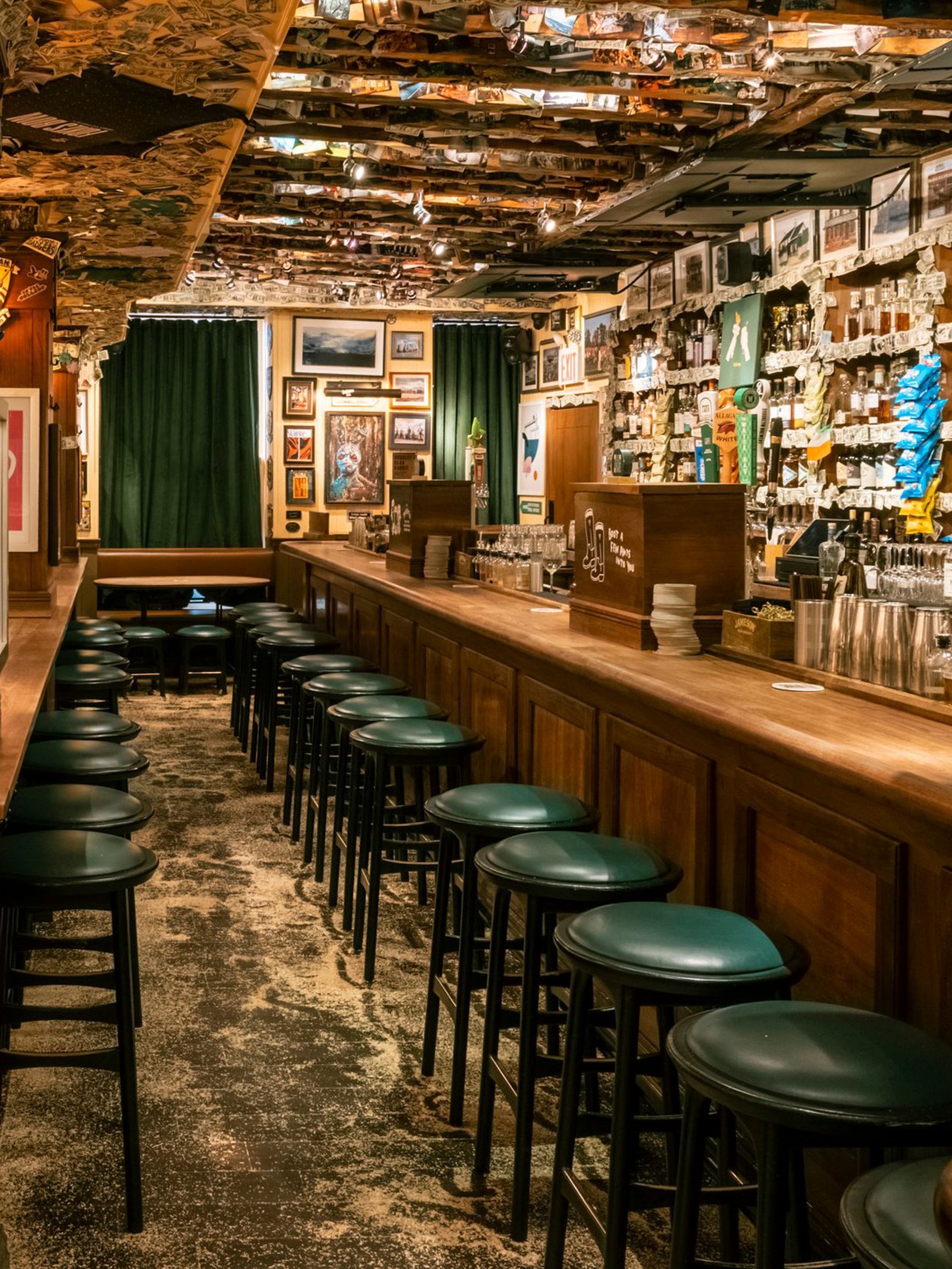 A wide shot of a traditional dark wood bar counter in a Manhattan Irish pub.