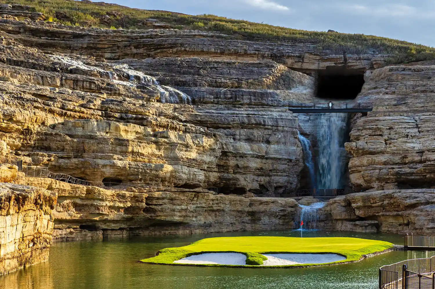 The 19th hole of Payne's Valley golf course featuring a waterfall and rock face.