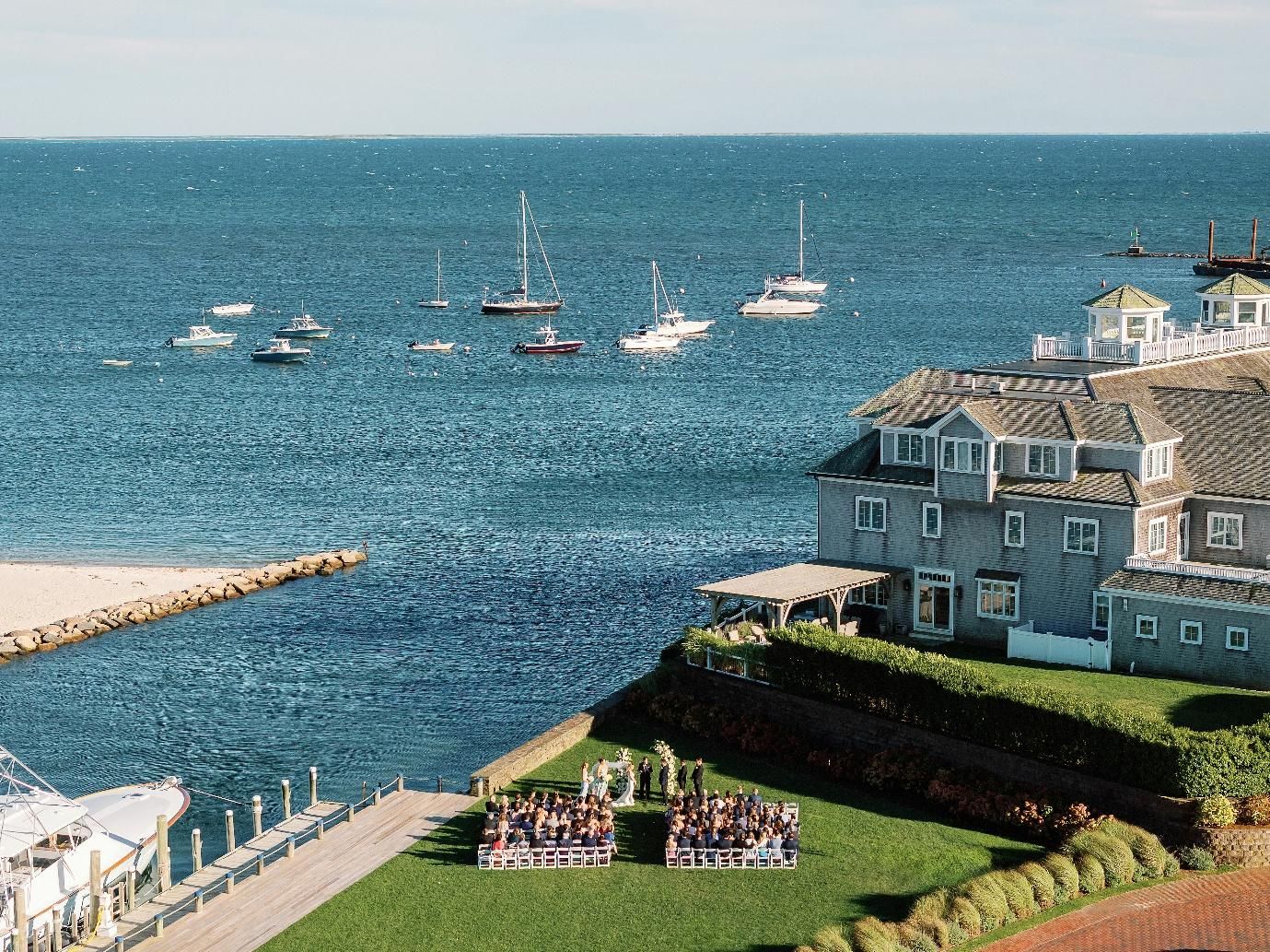 Sailboats on the water during sunset at a Cape Cod waterfront venue.