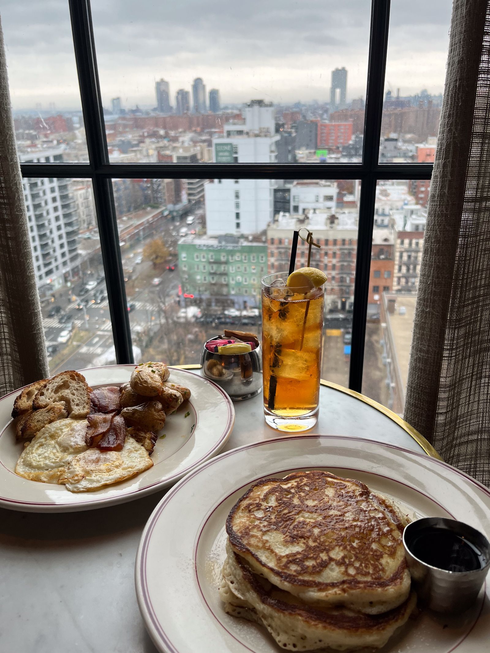 Breakfast spread at Dirty French restaurant including pancakes and brunch items.