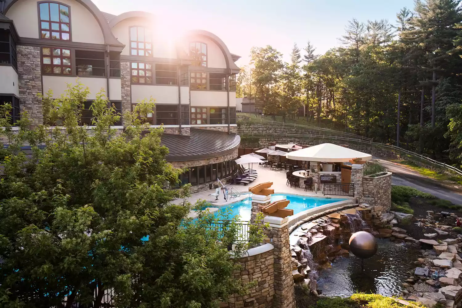 Exterior view of the Sundara Inn & Spa building surrounded by pine trees in Wisconsin.