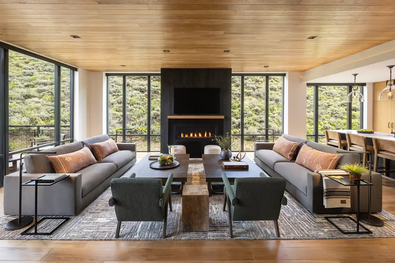A contemporary living room with floor-to-ceiling windows overlooking a Wyoming landscape.