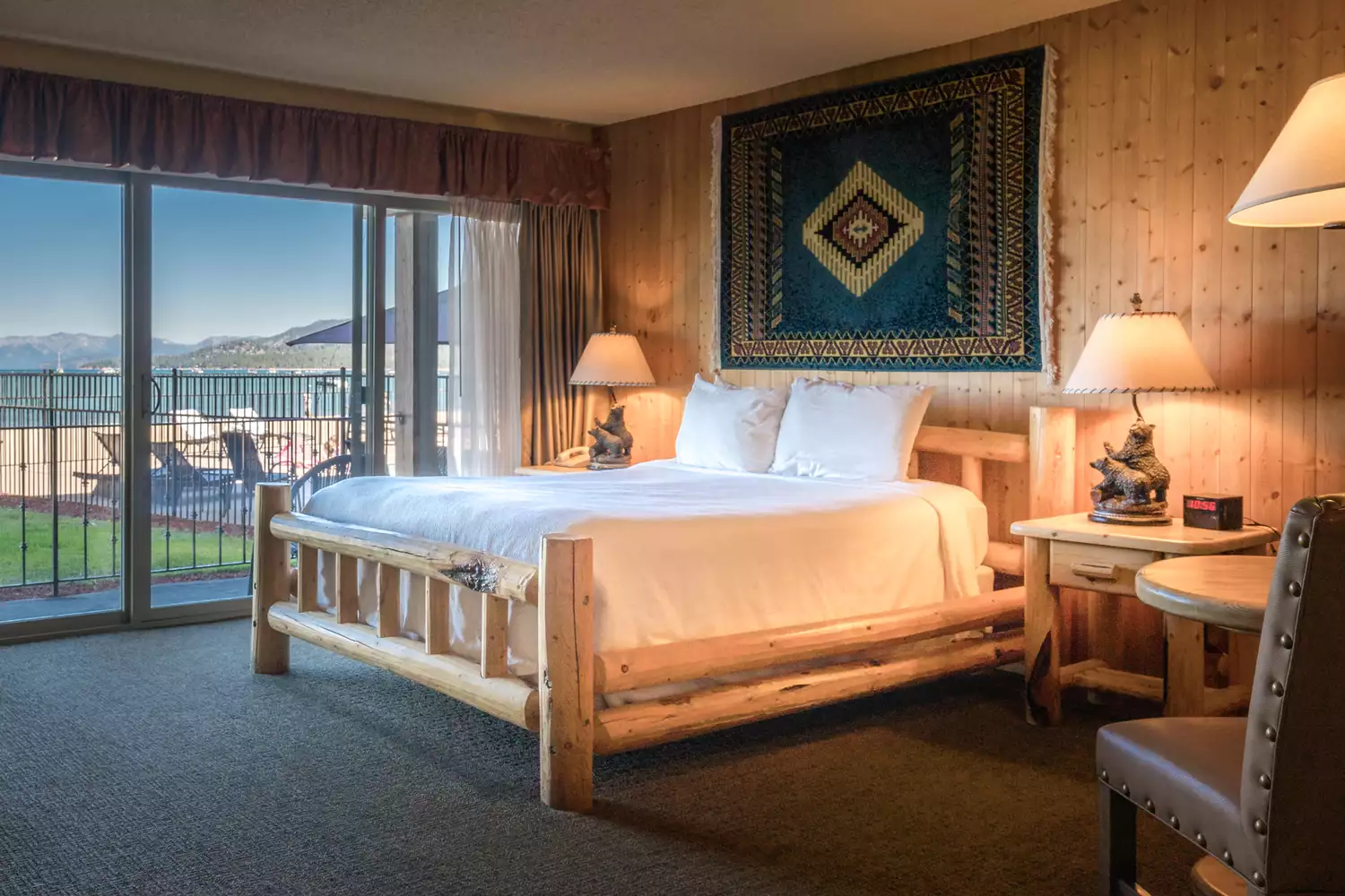 Interior of a guest room at Tahoe Lakeshore Lodge showing lake views through the window.