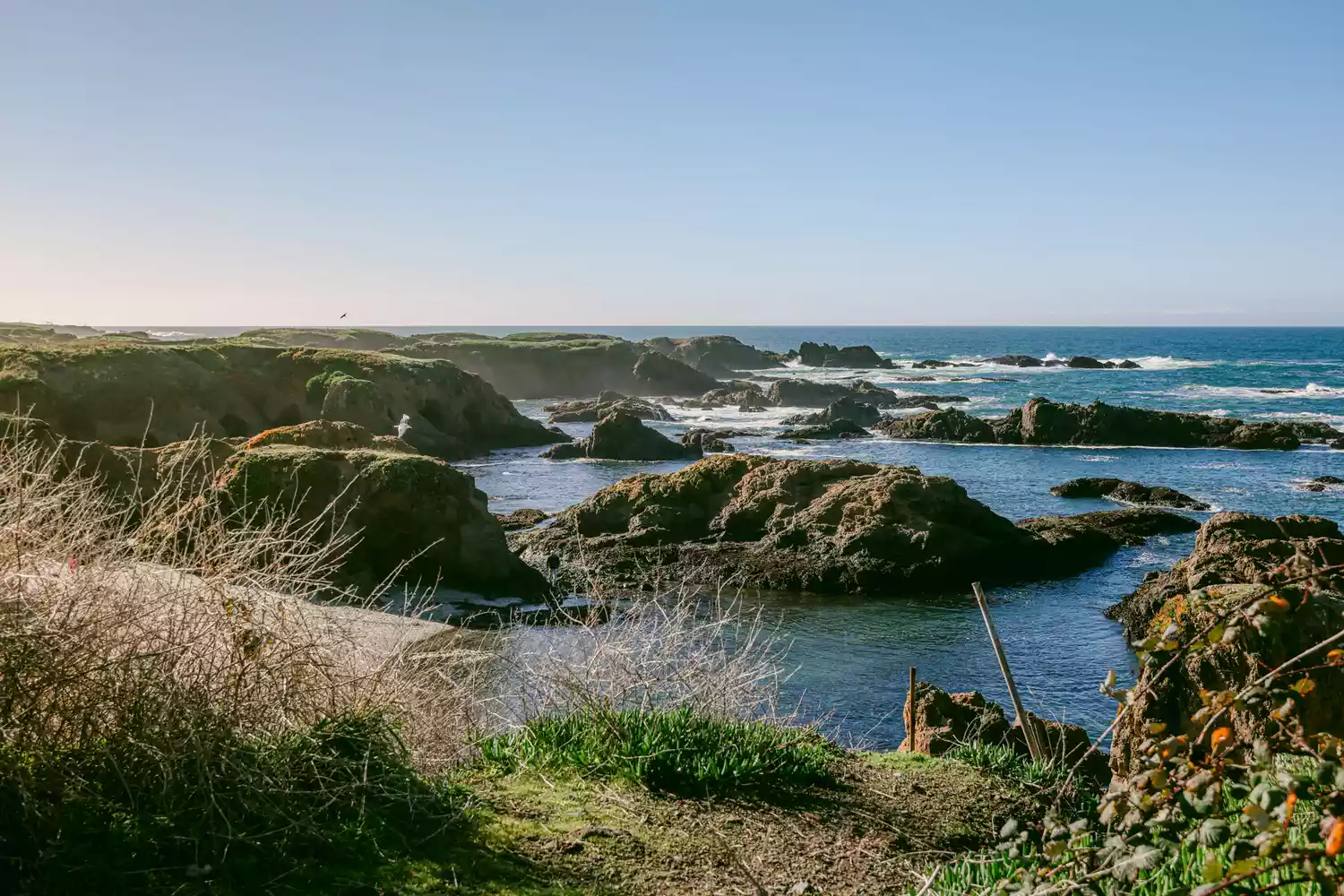 Dramatic rocky cliffs and ocean waves at the Noyo Headlands Coastal Trail area.