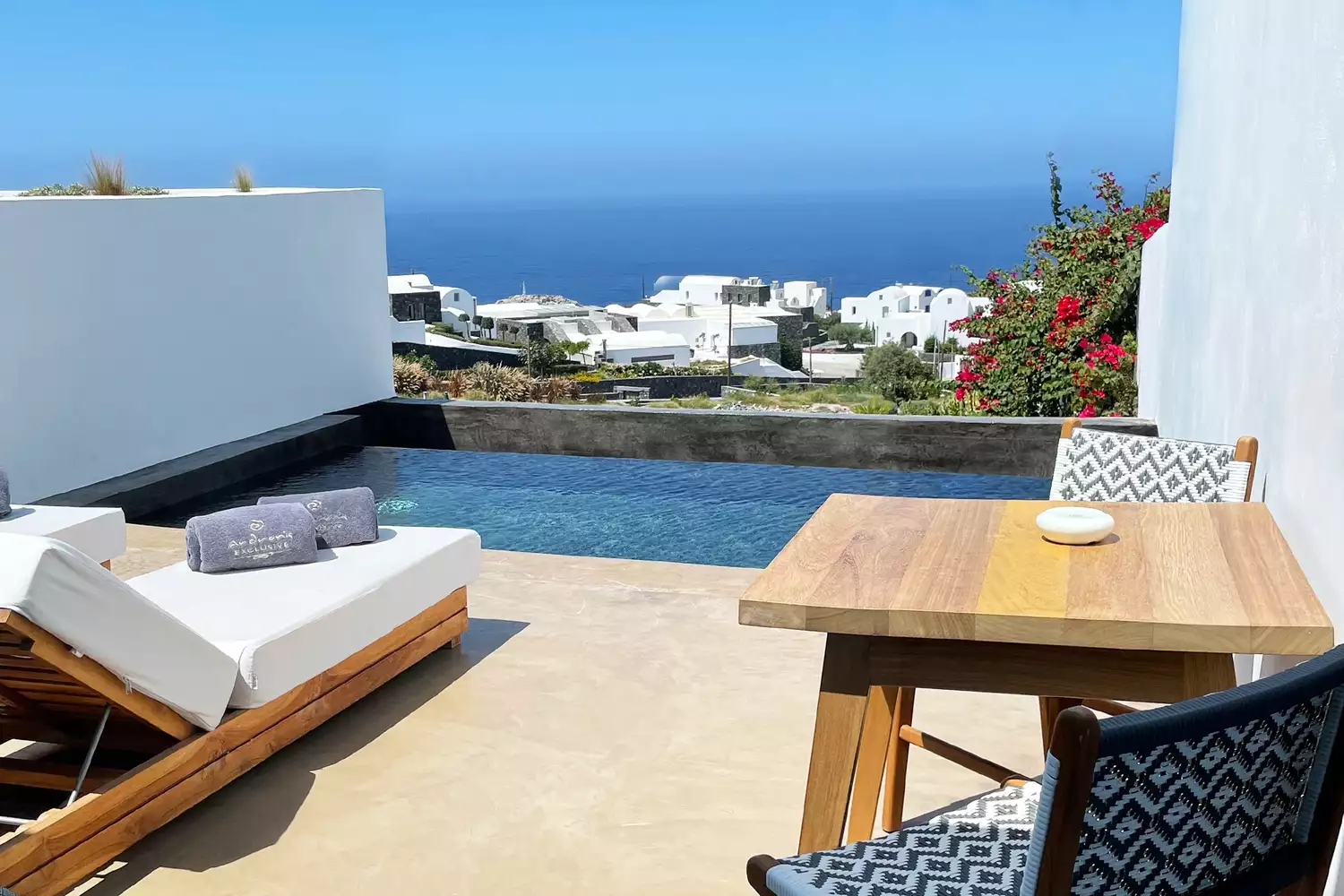 A private infinity plunge pool on a suite terrace overlooking the Aegean landscape in Oia.