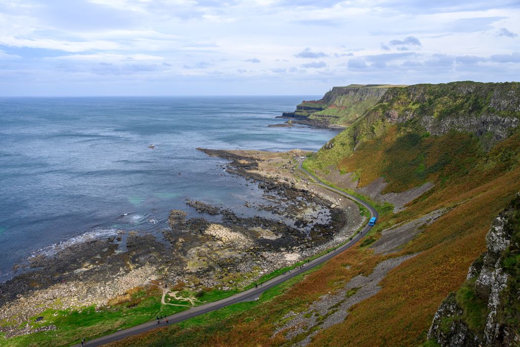 Hexagonal basalt rock columns rising from the sea at Giant's Causeway in Northern Ireland.