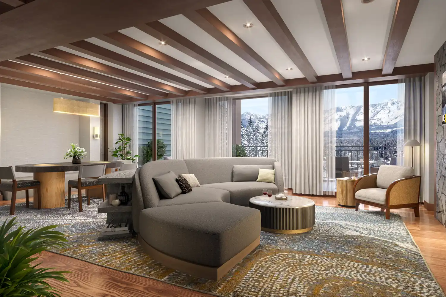 Modern luxury suite living area at The Ritz-Carlton featuring large floor-to-ceiling windows with a snowy mountain view.