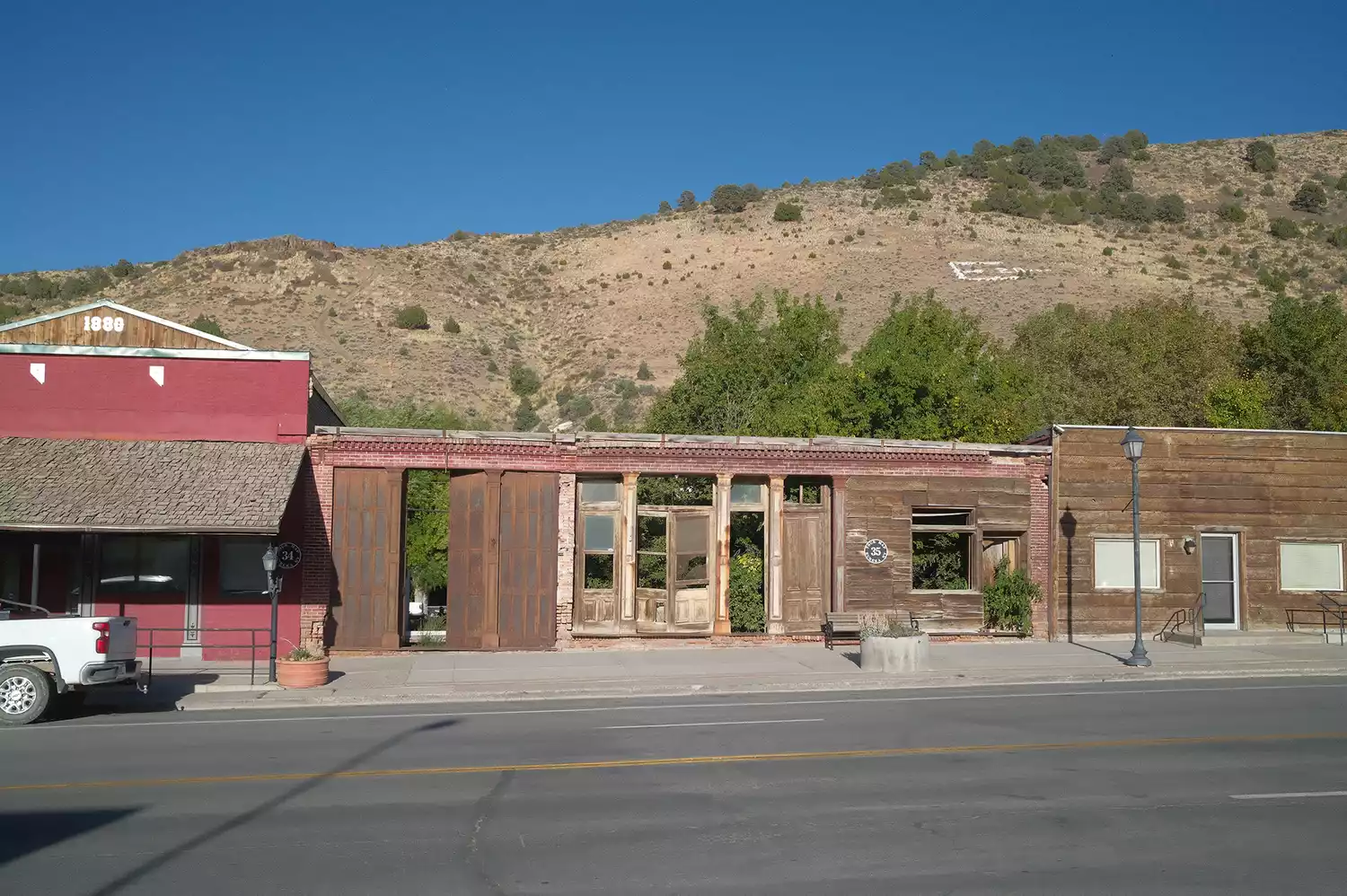 Wide shot of the historic downtown street in Eureka, Nevada, surrounded by mountains.