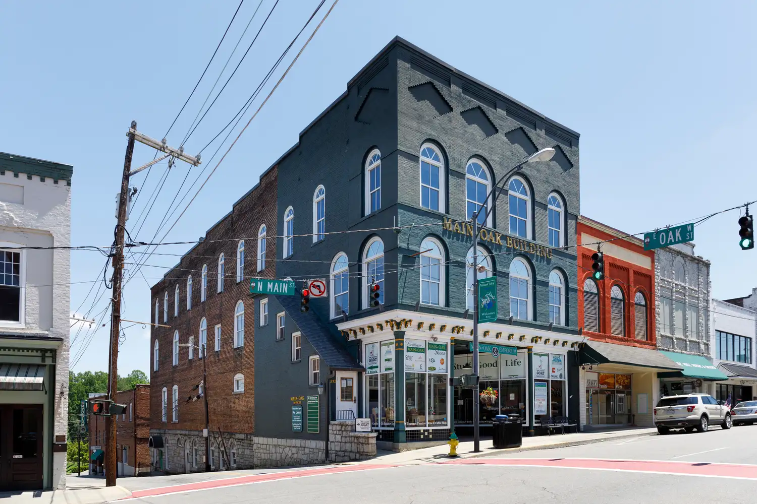 A classic brick commercial building in the heart of Mount Airy showing early 20th-century architecture.