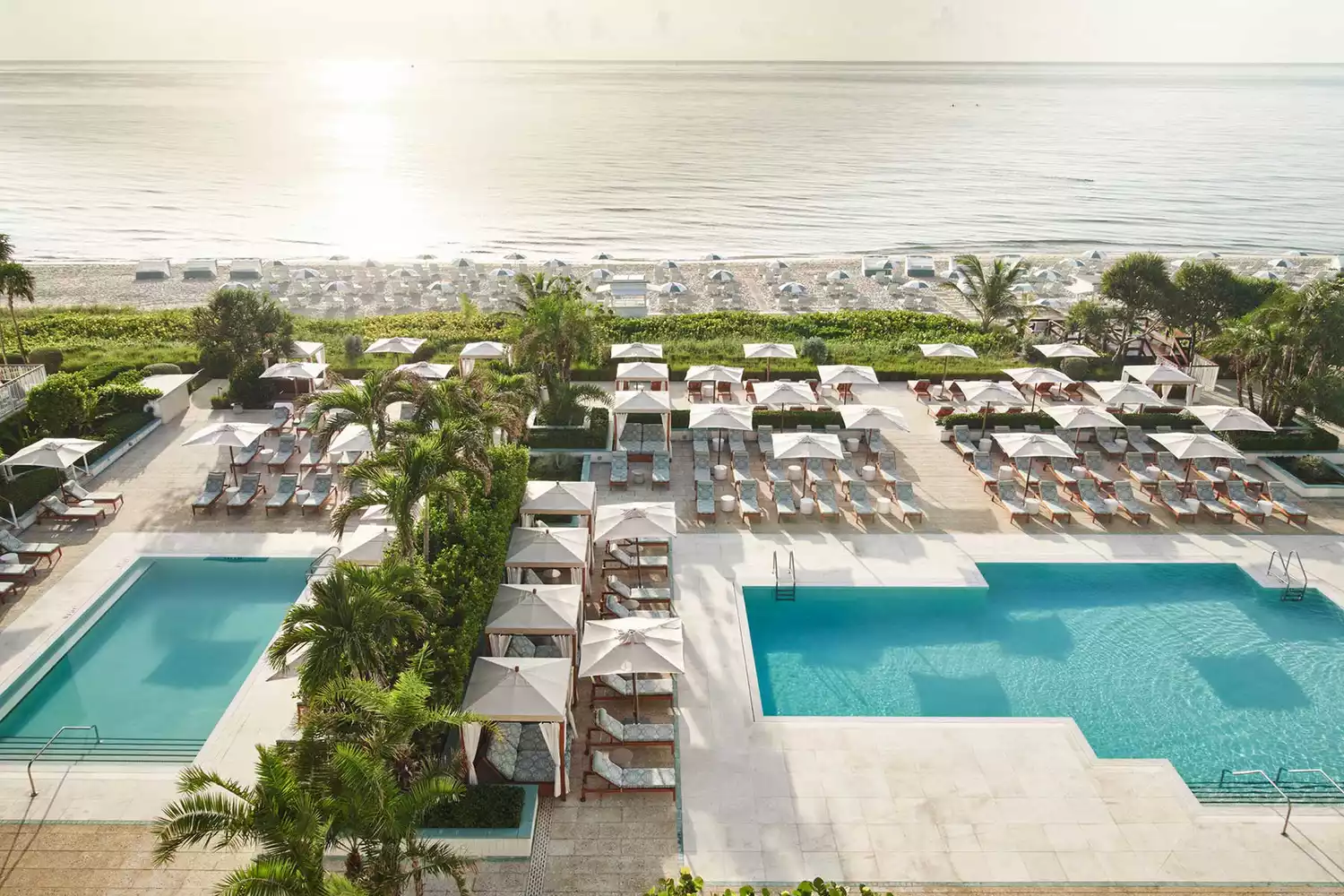 Luxury pool deck at Four Seasons Resort Palm Beach bordering the Atlantic coastline.